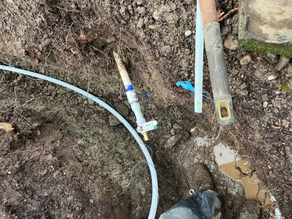 Pipe and tools in muddy ground