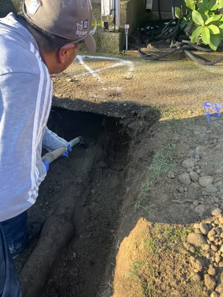 Man digging in the ground.