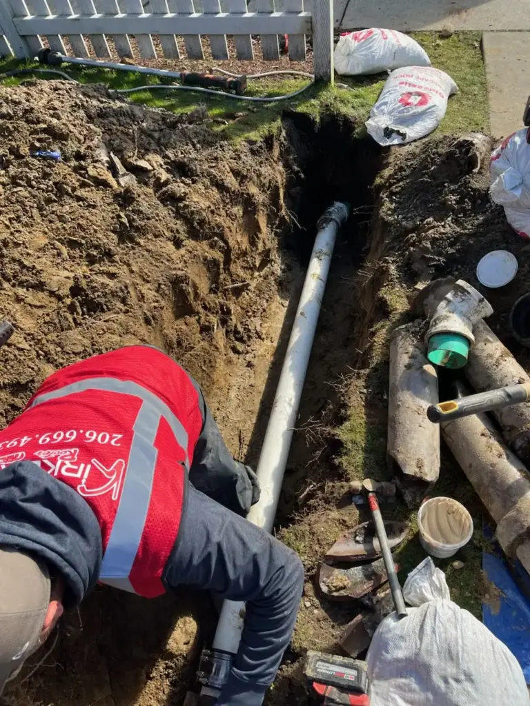 Worker repairing underground drainage pipe