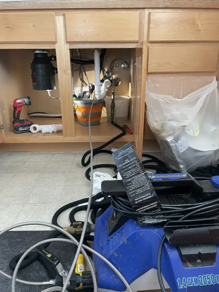 Plumbing tools and equipment under sink