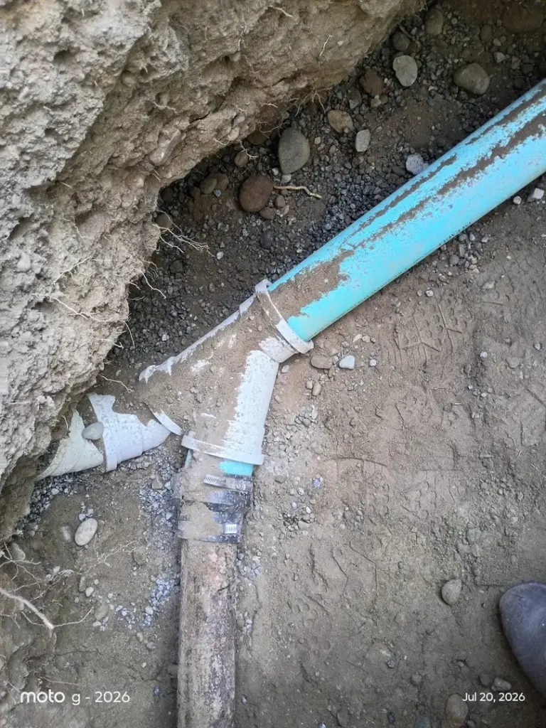 Broken blue pipe in dirt